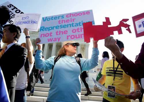 Demonstrators rally during oral arguments in Gill v. Whitford, a case about partisan gerrymandering in electoral districts, at the Supreme Court in Washington, U.S., October 3, 2017. REUTERS/Joshua Roberts - RC1CF13AEFC0