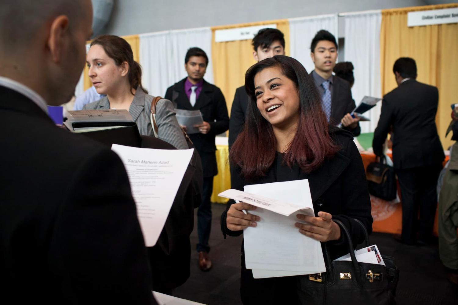 Sarah Azad, a senior majoring in telecommunications at New York City College of Technology, meets with a spokesperson for Hatstand Consulting at the 2012 Big Apple Job and Internship Fair at the Javits Center in New York, April 27, 2012. The job fair was organized specifically for students from the various City University of New York (CUNY) schools. REUTERS/Andrew Burton (UNITED STATES - Tags: BUSINESS EMPLOYMENT) - GM1E84S0HYK01