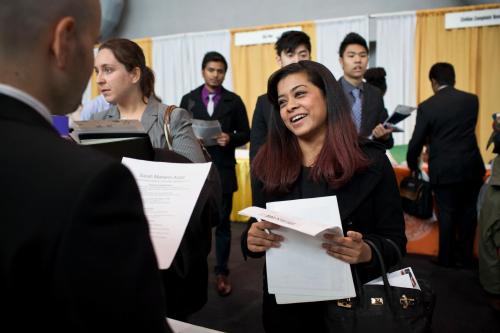 Sarah Azad, a senior majoring in telecommunications at New York City College of Technology, meets with a spokesperson for Hatstand Consulting at the 2012 Big Apple Job and Internship Fair at the Javits Center in New York, April 27, 2012. The job fair was organized specifically for students from the various City University of New York (CUNY) schools. REUTERS/Andrew Burton (UNITED STATES - Tags: BUSINESS EMPLOYMENT) - GM1E84S0HYK01