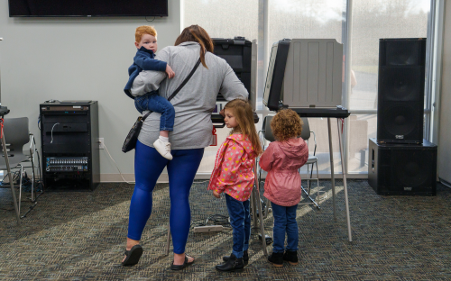 Nov 8, 2022; Avon, IN, USA; Before heading to preschool to drop off her children, Sydney Bailey votes Tuesday, Nov. 8, 2022, while holding her son, Rhett, 2, at Radiant Bible Church in Avon, Indiana. Daughters Wailyn, 5, and Emersyn, 4, stand nearby. "Did we have fun voting?" Bailey asked her children. "We didn't vote," Emersyn replied as she looked at her siblings and giggled. Mandatory Credit: Mykal McEldowney-USA TODAY NETWORK
