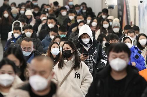 People wearing face masks walk in a subway station in Beijing during rush hour on Dec. 20, 2022, amid a rise in COVID-19 infections. (Kyodo)==KyodoNO USE JAPAN