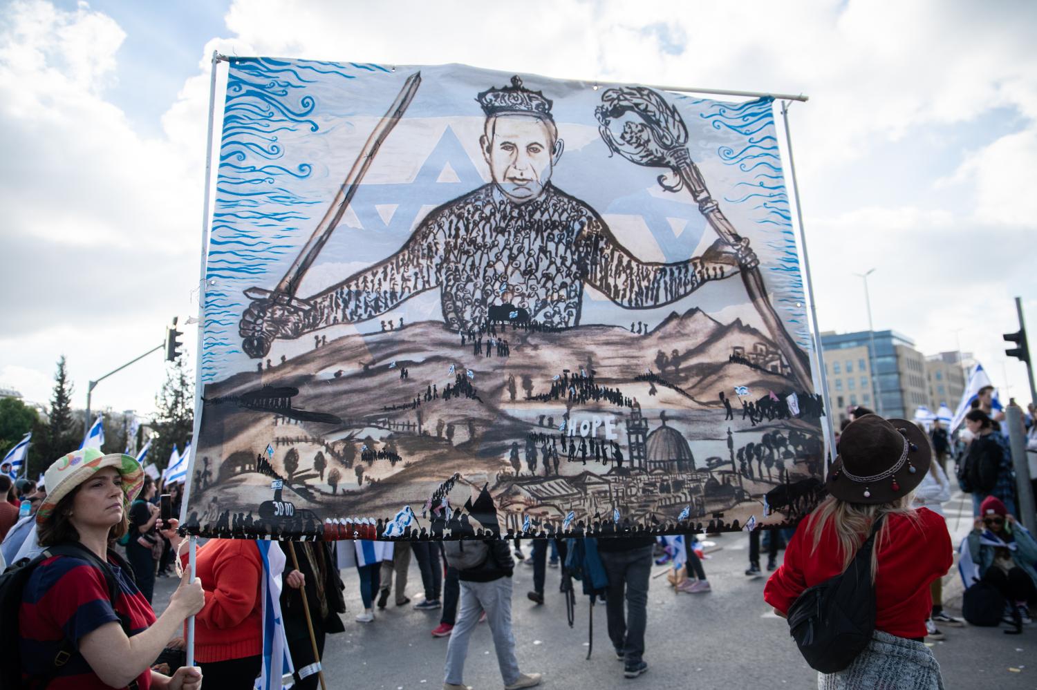 Protestors against the reform hold a hand-painted sign of Leviathan (Hobbes book) cover with the face of Prime Minister Benjamin Netanyahu. Tens of thousands protests in Jerusalem against Netanyahus far-right government and its controversial legal reform. Mar 27th 2023. (Photo by Matan Golan/Sipa USA).No Use Germany.