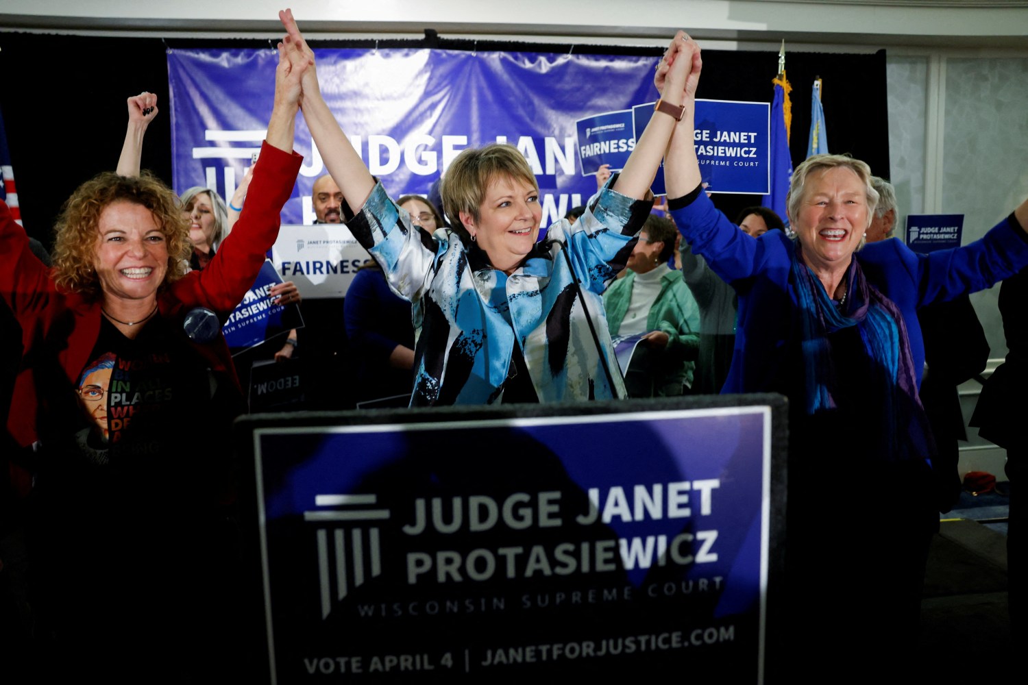 Wisconsin Supreme Court candidate Janet Protasiewicz celebrates alongside Wisconsin Supreme Court Judges Rebecca Dallet and Ann Walsh Bradley, after the race was called for her during her election night watch party in Milwaukee, Wisconsin, U.S., April 4, 2023. REUTERS/Evelyn Hockstein 