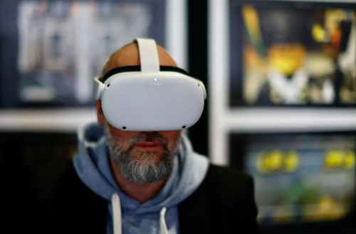 FILE PHOTO: A visitor wears virtual reality goggles at the World Artificial Intelligence Cannes Festival (WAICF) in Cannes, France, February 10, 2023.  REUTERS/Eric Gaillard