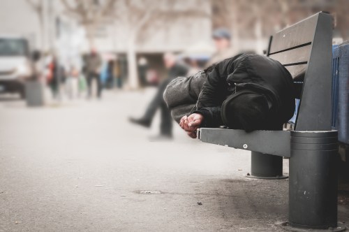 Homeless person on a bench