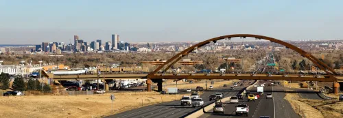 Automobile Traffic passes under a bridge that carries trains for public transit in the Denver Metro area Photo: Shutterstock