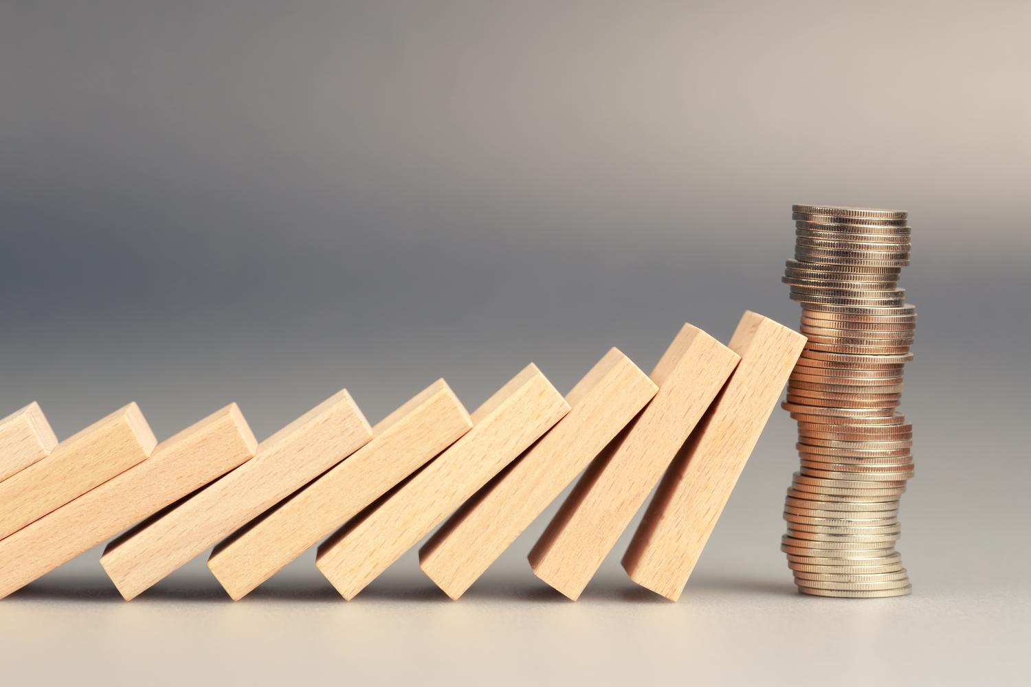 dominos against stack of coins