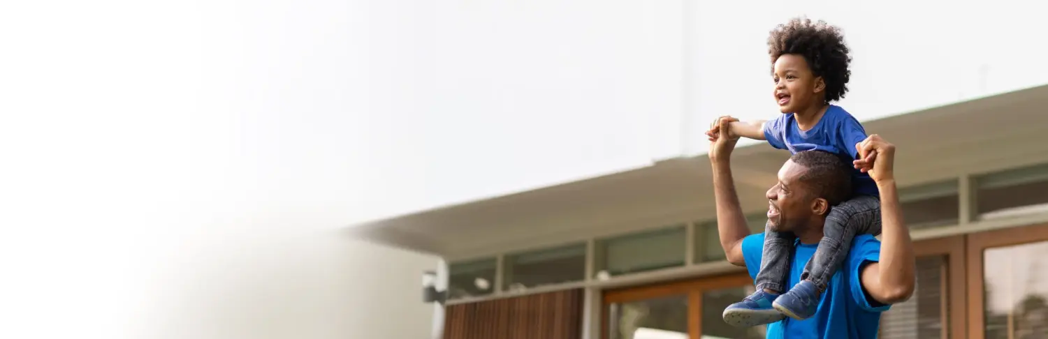 Happy Black African American Brazilian Father carrying his little boy playing together outdoor. Family Having fun on holiday. Panoramic, Banner. Photo: Shutterstock