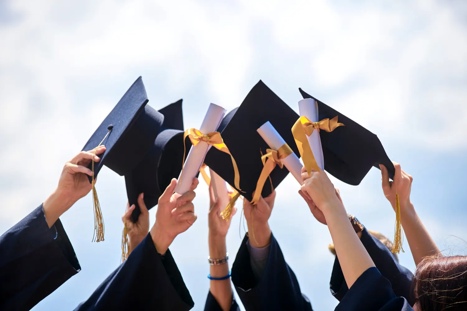 graduation caps in the air