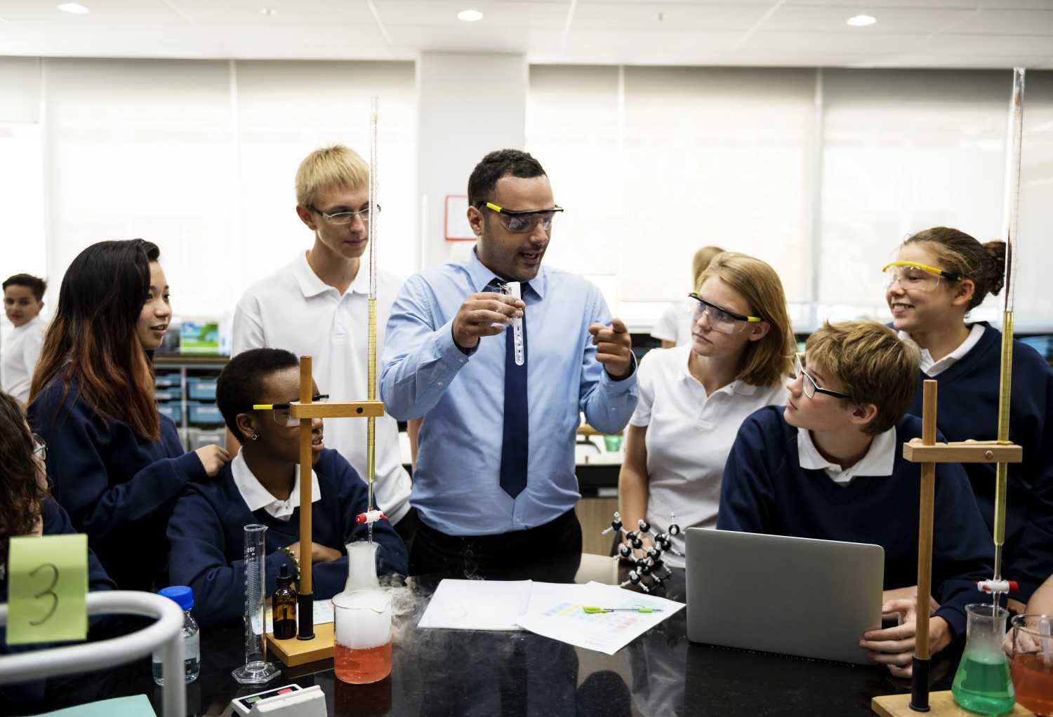 Science teacher showing students experiment