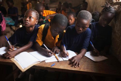 Students share a desk during a mathematics class at the Every Nation Academy private school in the city of Makeni in Sierra Leone, April 20, 2012.  REUTERS/Finbarr O'Reilly (SIERRA LEONE - Tags: EDUCATION SOCIETY TPX IMAGES OF THE DAY)