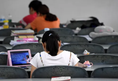 --FILE--A candidate learns online for the 2019 postgraduate entrance exam at a classroom in Wuhan city, central China's Hubei province, 30 July 2018. Online education is gaining momentum in China with the market scale expected to exceed 714 billion yuan ($104 billion) by 2025, a recent report from UBS Securities said. According to the UBS report, the Chinese online education market will grow markedly from the 29 billion yuan reported last year. Government support, technological progress, and a cultural emphasis on education have all contributed to a burgeoning online education market in China, said Liu Jiehao, an analyst at consultancy iiMedia. This combination of factors has given the country's online education a boost, and analysts point out that Chinese parents are a key driver. Edwin Chen, an analyst from UBS, said: "Chinese parents have high expectations for their children, wanting their kids to get into Tsinghua or Peking University. This is creating huge demand."No Use China. No Use France.