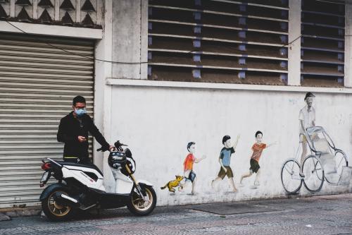 A man is about to go on a motorbike ride. Ho Chi Minh City, Vietnam, March 9, 2020. Un homme sapprete a prendre son scooter. Ho Chi Minh Ville, Vietnam, 9 Mars 2020.NO USE FRANCE