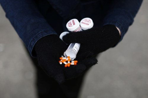 A fentanyl user displays a "safe supply" of opioid alternatives, including morphine pills, provided by the local health unit to combat overdoses due to poisonous additives and to support addicts and the homeless into practicing social distancing to help slow the spread of coronavirus disease (COVID-19) in the Downtown Eastside of Vancouver, British Columbia, Canada April 6, 2020. Picture taken April 6, 2020. REUTERS/Jesse Winter