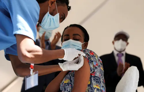 A woman receives the AstraZeneca/Oxford vaccine under the COVAX scheme against the coronavirus disease (COVID-19) at the Eka Kotebe General Hospital in Addis Ababa, Ethiopia March 13, 2021. REUTERS/Tiksa Negeri