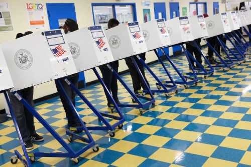People fill ballots in privacy booths at a polling station at the Jackie Robinson School during the New York City mayoral election in Brooklyn, New York, U.S., November 2, 2021.