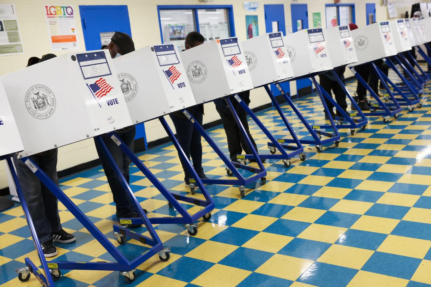 People fill ballots in privacy booths at a polling station at the Jackie Robinson School during the New York City mayoral election in Brooklyn, New York, U.S., November 2, 2021.
