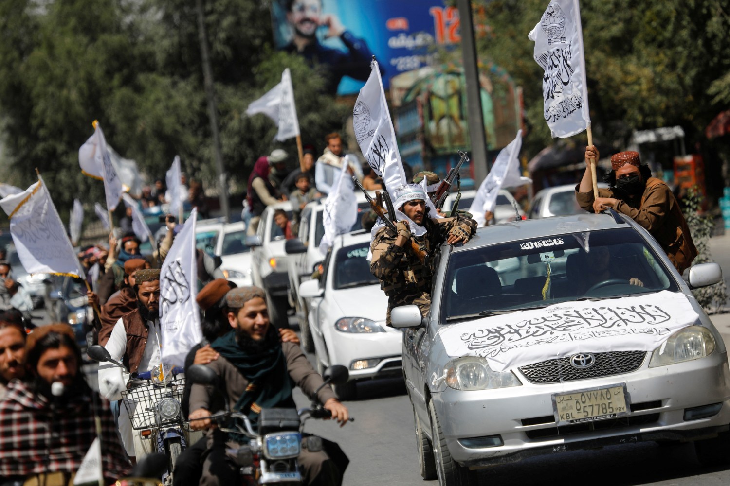 Taliban members drive in a convoy to celebrate the first anniversary of the withdrawal of U.S. troops from Afghanistan, along a street in Kabul, Afghanistan, August 31, 2022. REUTERS/Ali Khara