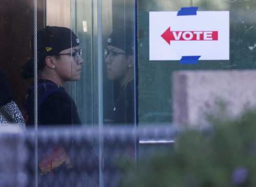 A person exits a polling location after voting in the U.S. midterm elections, at the Burton Barr Central Library, in Phoenix, Arizona, U.S., November 8, 2022. REUTERS/Jim Urquhart