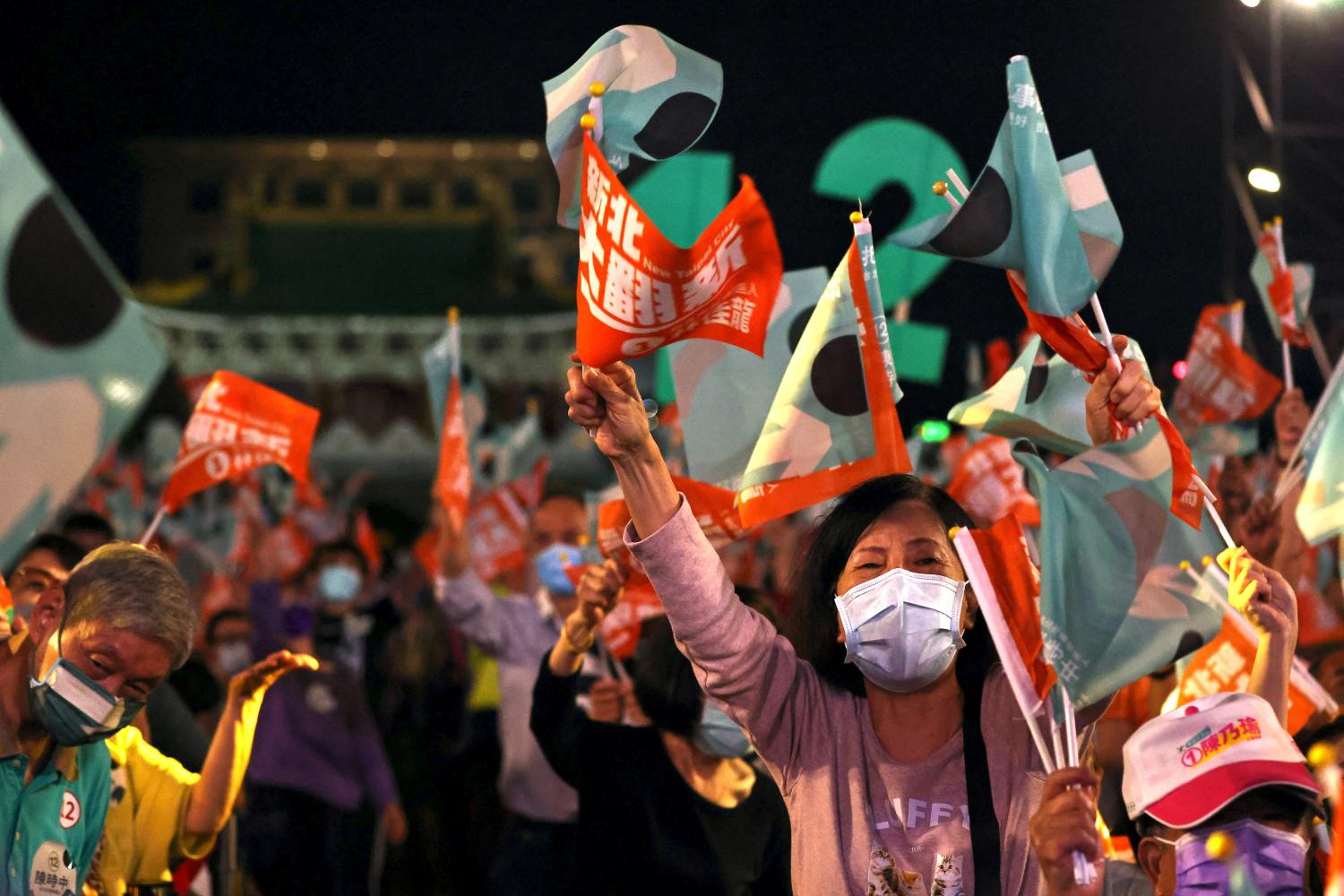 People wave flags at the Taiwan's ruling Democratic Progressive Party pre-election campaign rally ahead of mayoral elections in Taipei, Taiwan, November 12, 2022. REUTERS/Ann Wang