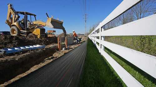 April 13, 2023; New Albany, Ohio, USA; Workers lay fiber optic cable piping as the St. Rt. 161 and Rt. 62 interchange is expanded in New Albany near the new Intel chip manufacturing plant. Mandatory Credit: Doral Chenoweth-The Columbus DispatchLEAD PHOTO 01 161 Expansion