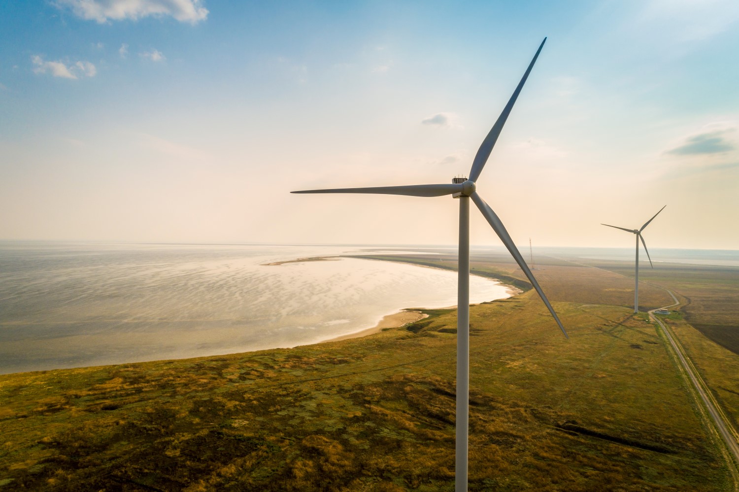 Aerial view of wind turbines on a sea shore.