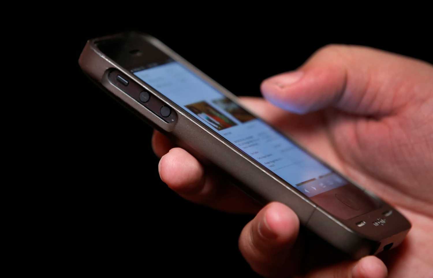 A man uses a smartphone in New York City, in this picture taken November 6, 2013. Twitter Inc raised the top end of its IPO price range by 25 percent and will close its books a day early, signaling strong demand for the most closely watched Silicon Valley debut since Facebook Inc last year. REUTERS/Mike Segar (UNITED STATES - Tags: SCIENCE TECHNOLOGY BUSINESS TELECOMS) - TM4E9B60XZA01