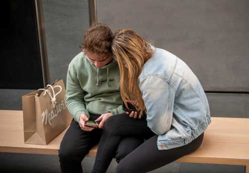 Teenagers look at phone