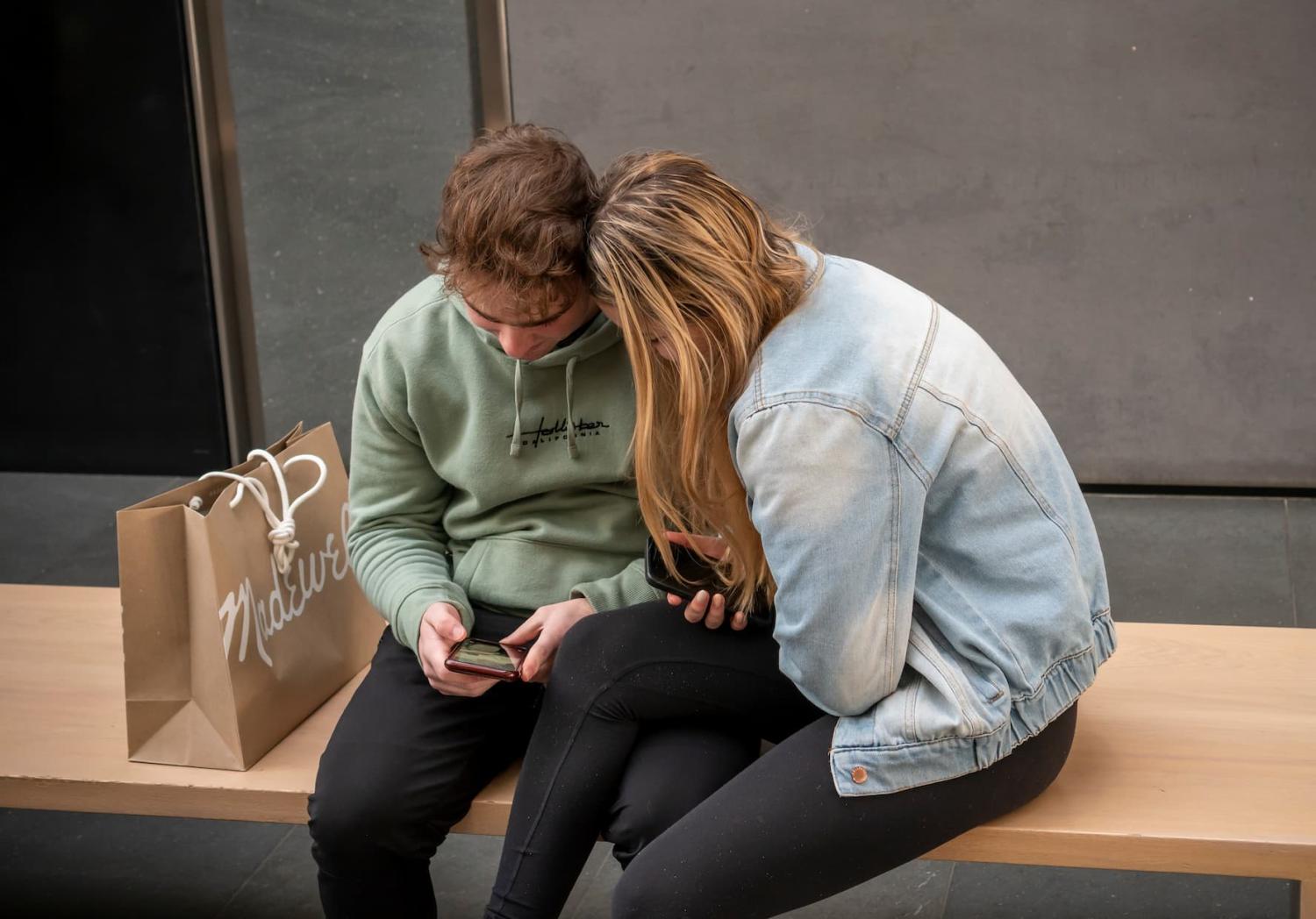 Teenagers look at phone
