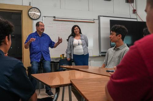 National Hispanic Institute founder and president Ernesto Nieto, left, and co-founder and executive vice president Gloria de Leon, right speak to students ahead of an NHI induction ceremony at William B. Travis High School on Sunday, May 7, 2023 in Austin.