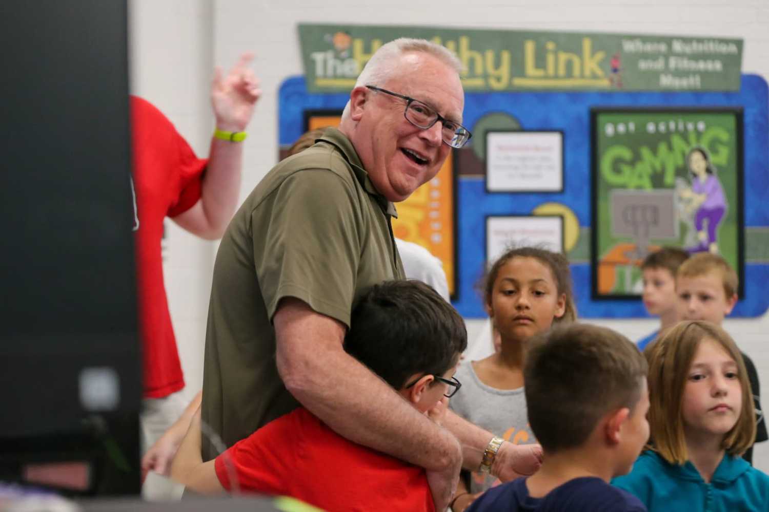 Rob Skaggs, Mintonye Elementary School principal, hugs his students after they held a surprise retirement celebration Skaggs, who will be retiring after serving as the school's principal for 24 years, on Wednesday, May 24, 2023, in Lafayette, Ind. Cardiologist Meder is pictured during a heart catheterization at the Heidelberg University Hospital (Universitaetsklinikum Heidelberg) in Heidelberg