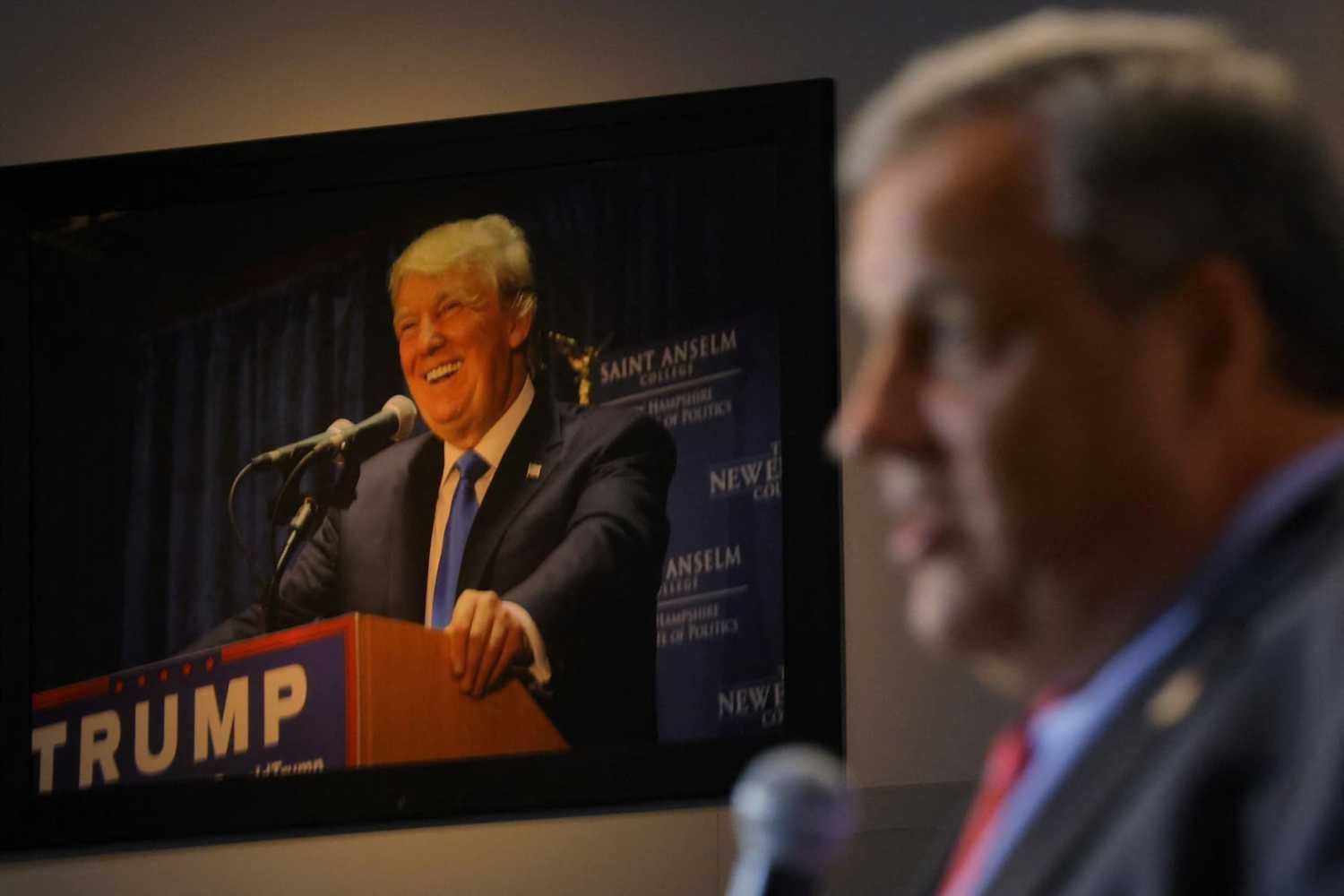 A photograph of former U.S. President Donald Trump hangs on the wall as former New Jersey Governor Chris Christie speaks at the Institute of Politics at St. Anselm College in Manchester, New Hampshire, U.S., March 27, 2023. REUTERS/Brian Snyder/File Photo