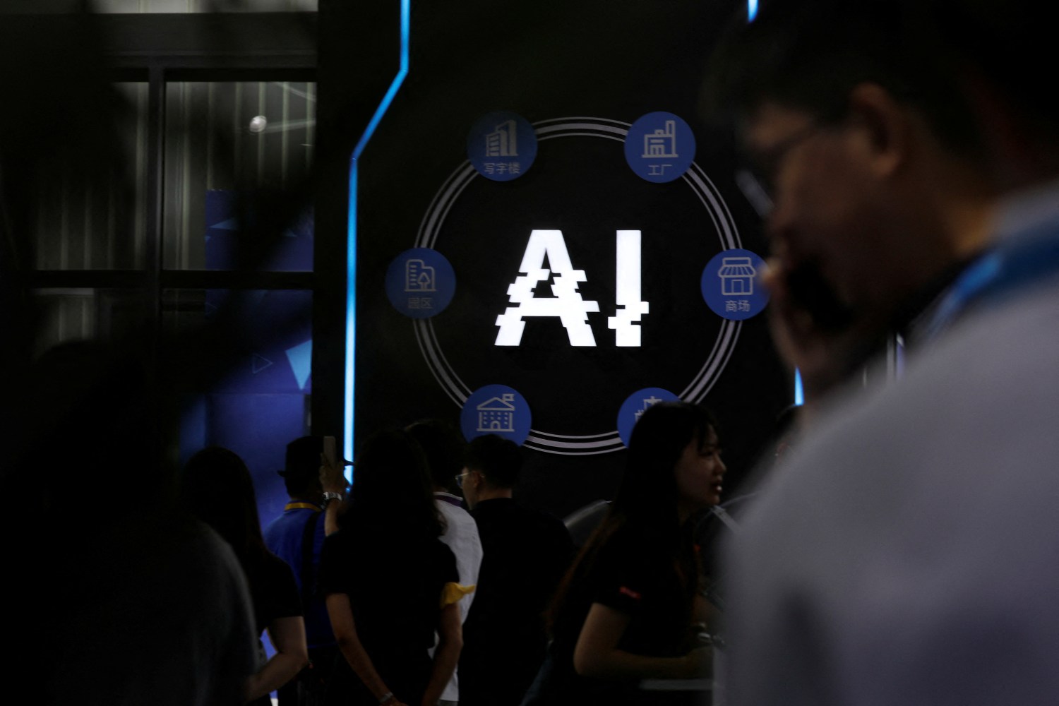 Visitors stand near a sign of artificial intelligence at an AI robot booth at Security China, an exhibition on public safety and security, in Beijing, China June 7, 2023. REUTERS/Florence Lo