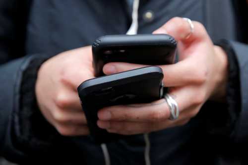 A woman uses her cell phones in Manhattan, New York.