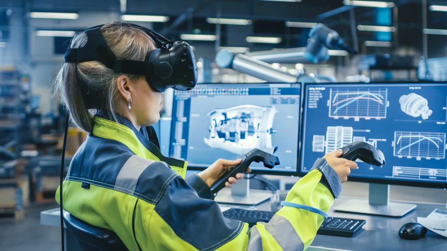 Factory: Female Industrial Engineer Wearing Virtual Reality Headset and Holding Controllers, She Uses VR technology for Industrial Design, Development and Prototyping in CAD Software.