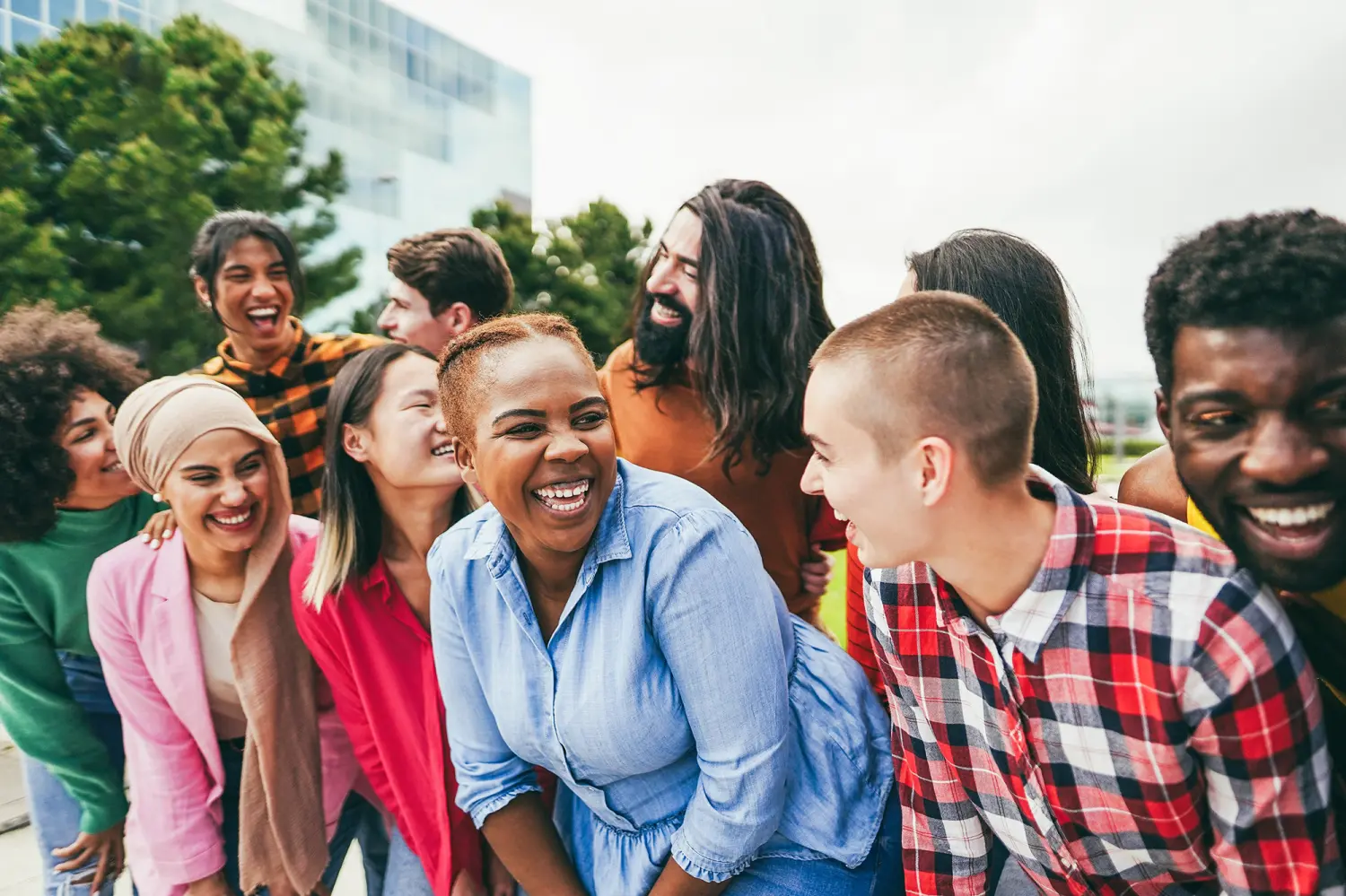 Young diverse people having fun outdoor laughing together - Focus on african woman face