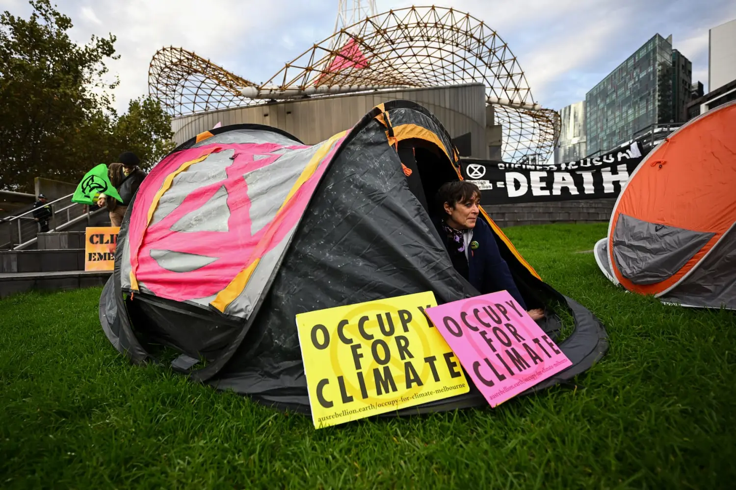 Activists from Extinction Rebellion Victoria stage a demonstration outside the the Arts Centre spire during a ‘Occupy for Climate’ protest in Melbourne, Friday, April 28, 2023. (AAP Image/Joel Carrett) NO ARCHIVINGNo Use Australia. No Use New Zealand.