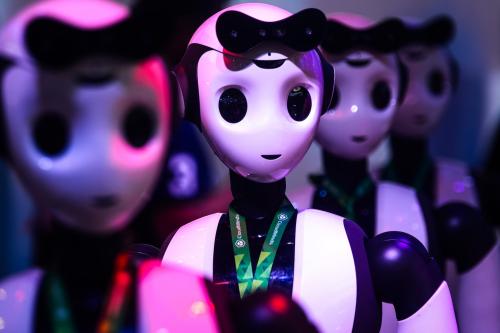 A row of four identical robots seen from the shoulders up.
