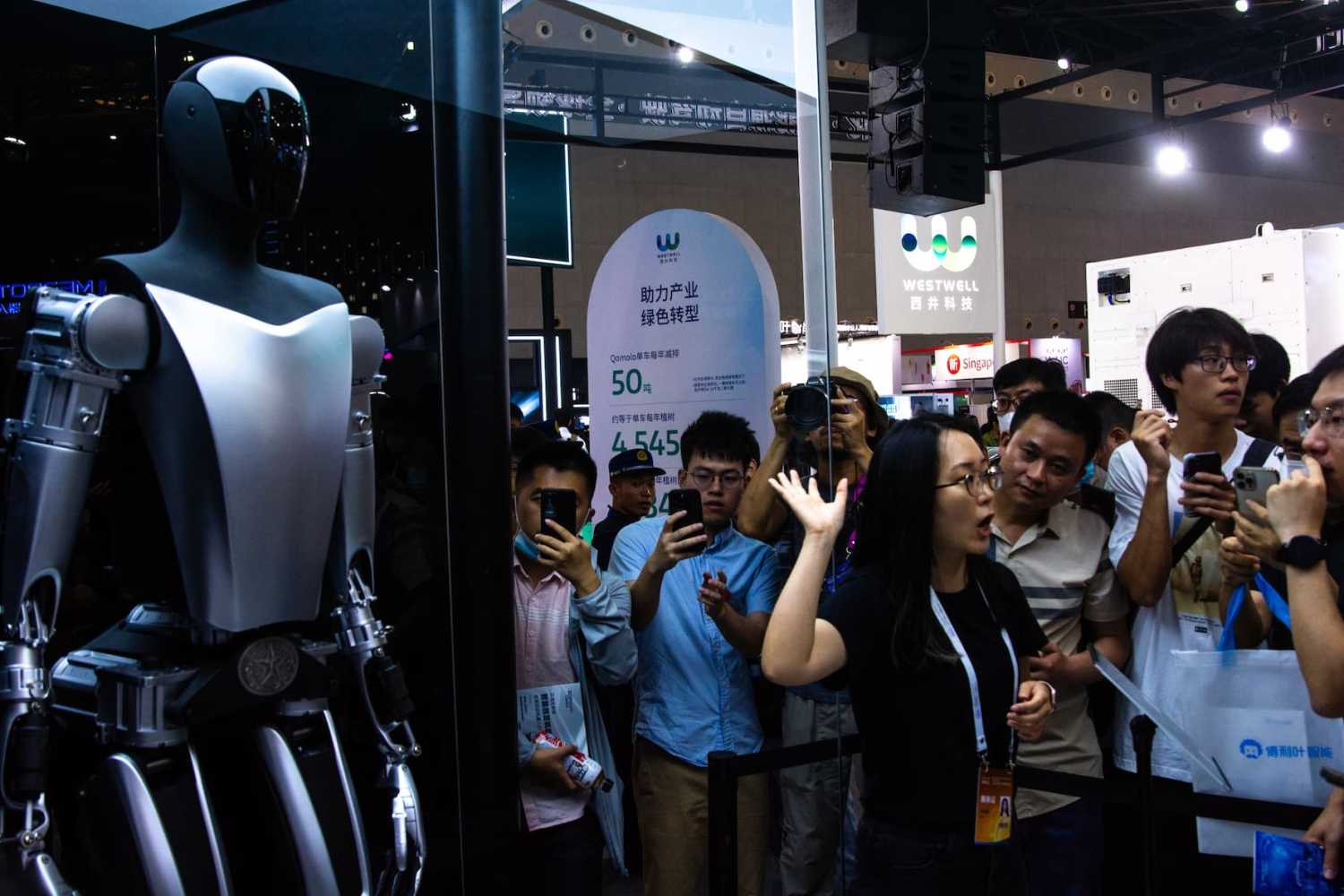 a Tesla bot is seen at Tesla booth during the opening of 2023 World Artificial intelligence conference in Shanghai, China on July 6, 2023 (Photo by Ying Tang/NurPhoto)