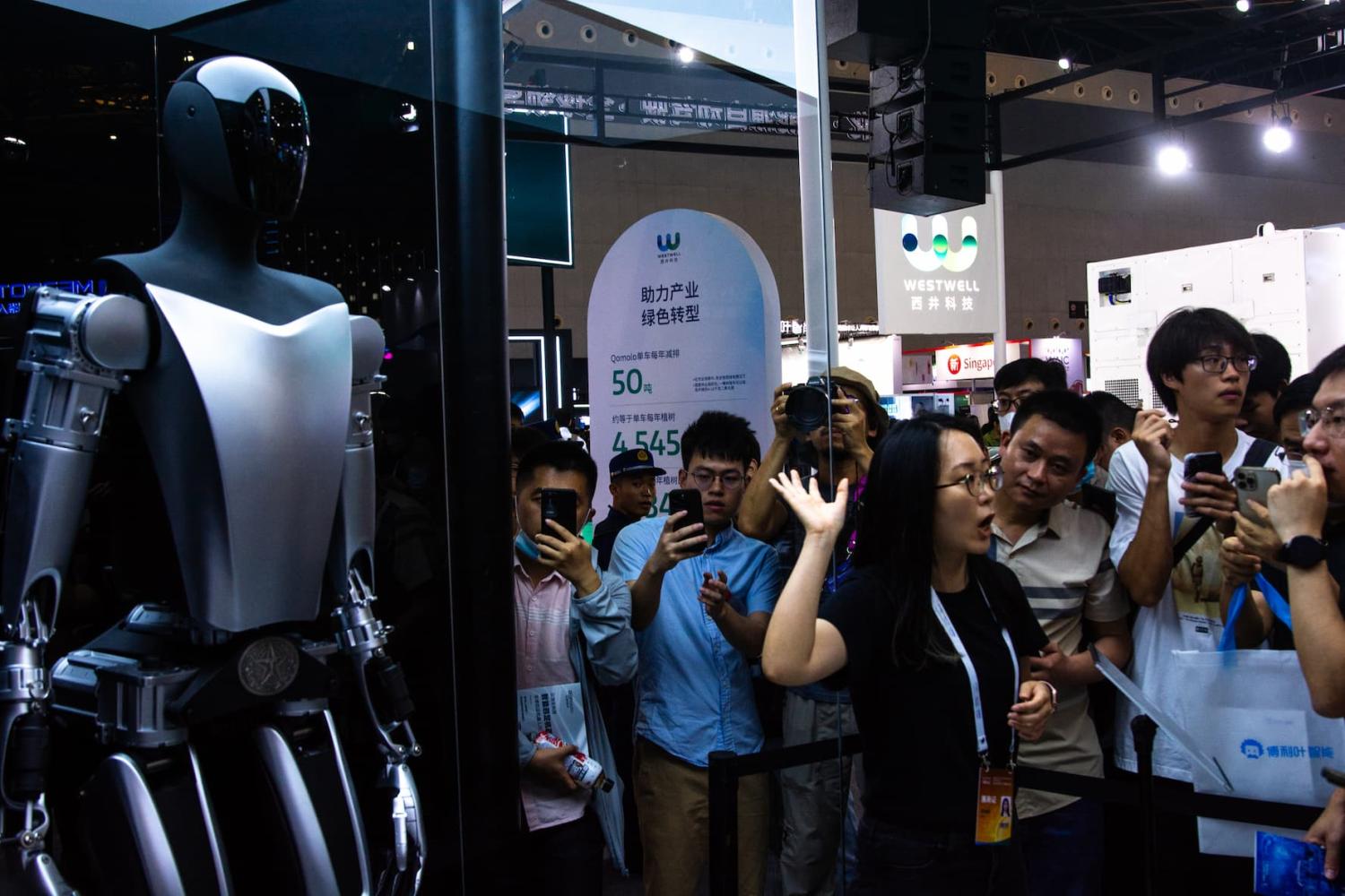 a Tesla bot is seen at Tesla booth during the opening of 2023 World Artificial intelligence conference in Shanghai, China on July 6, 2023 (Photo by Ying Tang/NurPhoto)