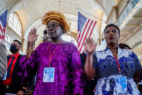 People take oath during naturalization ceremony at Ellis Island