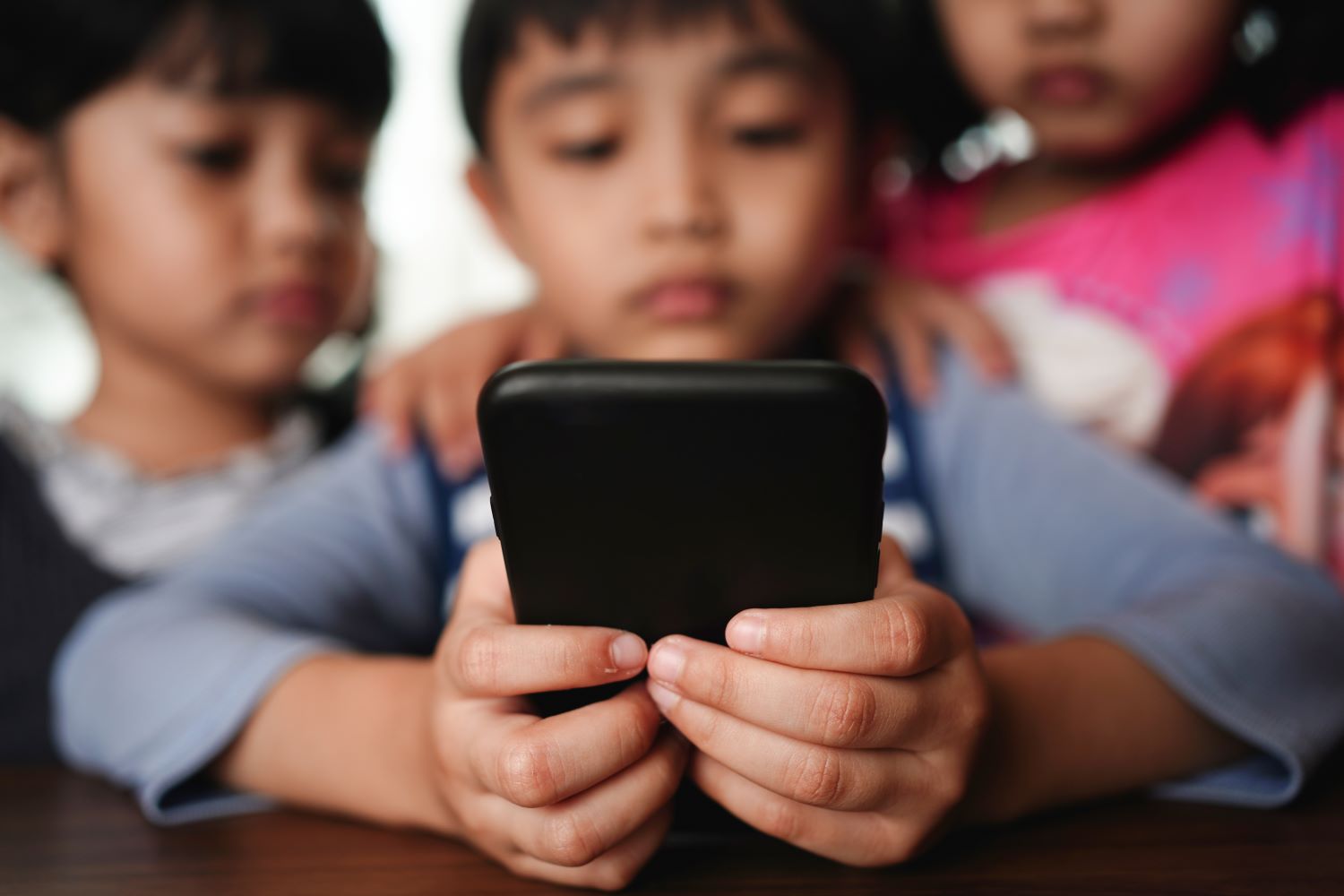 Children looking at a smartphone