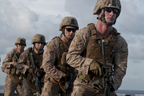 U.S.Marines take part in marksmanship training aboard the USS Peleliu in this handout photo