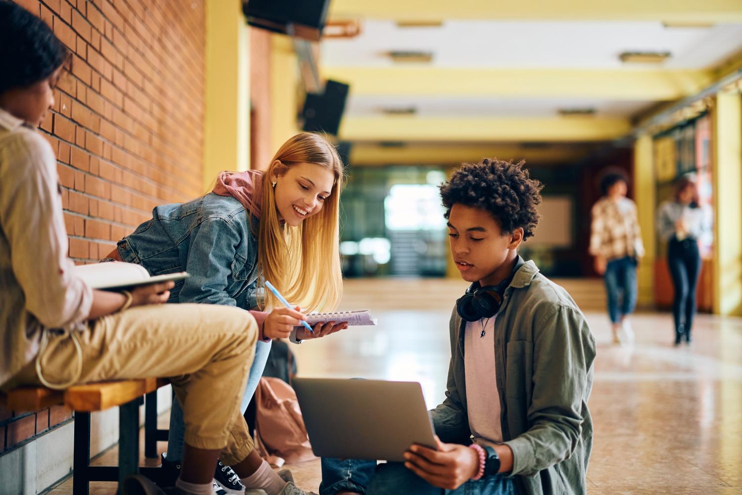 A student at a high school sits in front of a laptop and uses an AI tool.