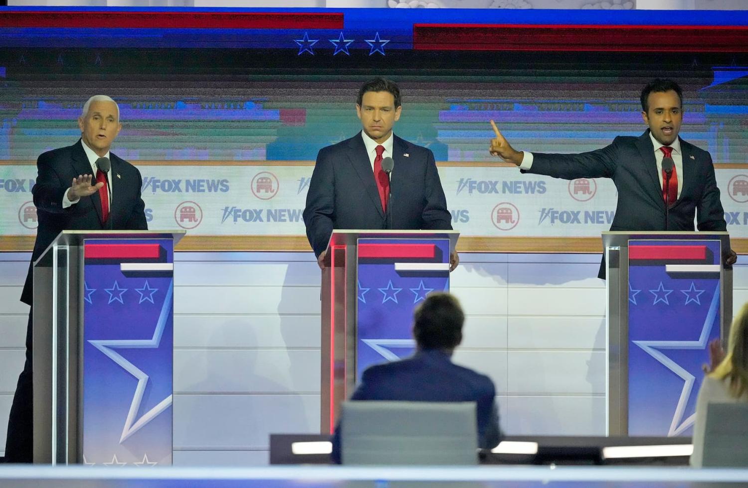 Republican presidential candidate former Vice President Mike Pence (left) and Republican presidential candidate Biotech entrepreneur Vivek Ramaswamy argue with Republican presidential candidate Florida governor Ron DeSantis in between at Fiserv Forum during the first 2023 Republican presidential debate in Milwaukee on Wednesday, Aug. 23, 2023. - Mike De Sisti / The Milwaukee Journal Sentinel ORG XMIT: MJS2308232147361535 (Via OlyDrop)