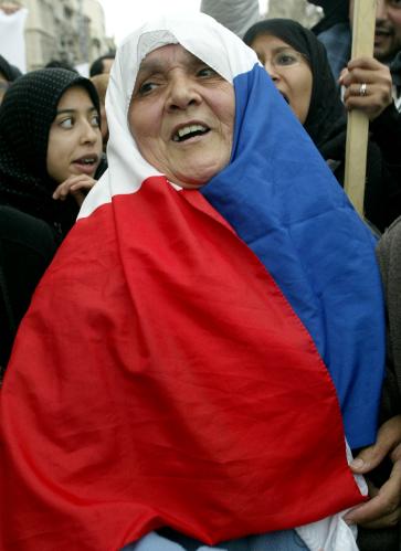 A Muslim woman wearing a French flag as a headscarf demonstrates in the streets of Marseille to protest against a looming ban on Islamic headscarves (hijab) in French state schools, January 17, 2004.