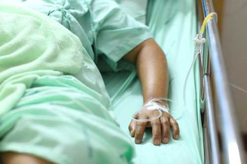 Person lying in a hospital bed