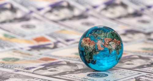 Globe on a wave of dollar bills