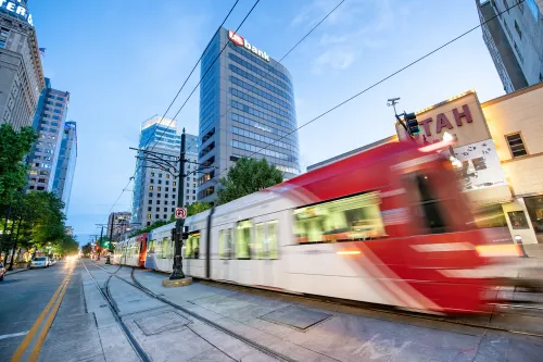 SALT LAKE CITY, UT - JULY 13, 2019: City tram speeds up at night.