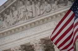 A detail view of the U.S Supreme Court and an American Flag, in Washington, D.C., on Friday December 10, 2021. REUTERS/Graeme Sloan/Sipa USA